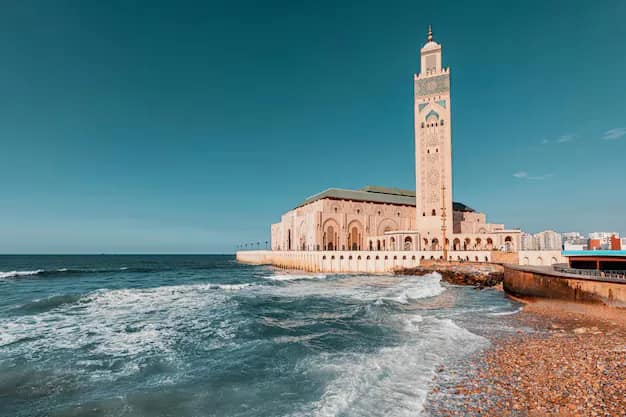 The Hassan II Mosque in Casablanca, Morocco, its tall minaret rising above the Atlantic Ocean
